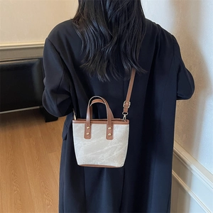Chic two-tone canvas and brown leather mini tote bag with adjustable shoulder strap