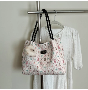 Quilted floral tote bag with cute bear pattern and white plush rabbit charm on a hanger