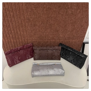 Detailed view of square clutches featuring premium faux snake skin texture in four colors