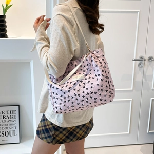 Bolso tote acolchado rosa con lazos negros y correas blancas para un estilo casual