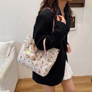 White cartoon printed tote bag with pink handles, plush bear charm and pearl chain decoration