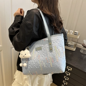 Light blue canvas tote bag with letter embroidery and cute cloud charm on shoulder