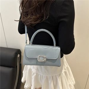 Elegant light blue leather crossbody bag with sparkling G buckle and top handle