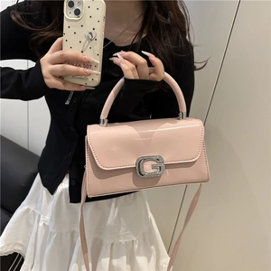 Chic pink top-handle crossbody bag with sparkling G-logo and patent finish