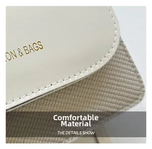 Macro detail of elegant cream bag showing honeycomb texture and fine stitching on the flap