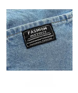 Detailed macro view of woven black logo label on high-quality blue denim fabric