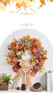 Detailed view of autumn wreath with maple leaves berries and pumpkin print bow decoration