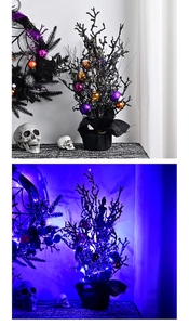 Detail of Halloween wreath and tree with skulls and blue LED lights in the dark