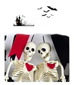 Close-up of Gothic skeleton couple with red hearts and silk ribbons for Halloween wreath