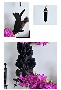 Detail of Halloween moon cat wreath with black faux roses and purple floral accents