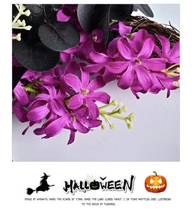 Detailed close-up of Halloween wreath with purple flowers and black faux leaves