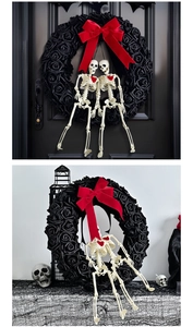Detailed view of Gothic Halloween wreath featuring black roses, red bow, and skeleton couple