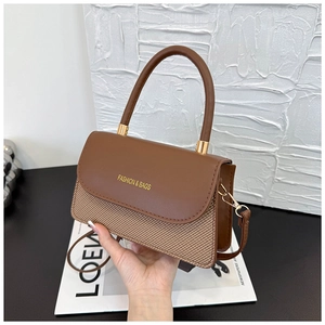 Detail view of the elegant brown contrast patchwork texture on the stylish crossbody bag