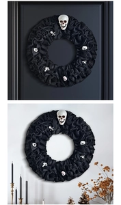 Detail of Halloween wreath with black mesh, skull accents and gothic party decor