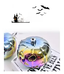 Close-up of iridescent Halloween pumpkin ornament with metallic finish and silver string