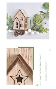 Detail of wooden Christmas house ornament with pine cones, white berries and star cutouts