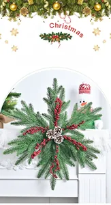 Christmas snowflake wreath with pine cones and red berries on a white fireplace mantle
