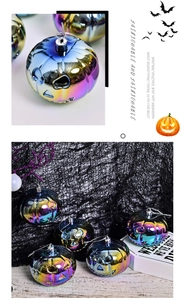 Close-up of iridescent Halloween pumpkin ornaments with a metallic gradient finish