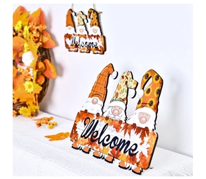 Detail of wooden gnome welcome sign with fall maple leaves for home tabletop decor