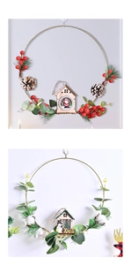 Detailed view of Christmas wreath with metal ring, pine cones, red berries and wood cottage