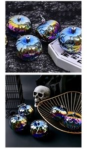 Macro view of 8cm iridescent pumpkin ornaments with classic Jack-o'-lantern carved faces