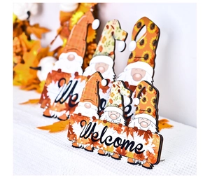 Detail of wooden gnome ornaments with Welcome signs and autumn sunflower decorations