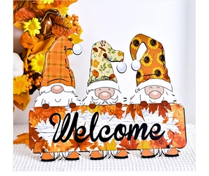 Close-up of Thanksgiving gnomes holding a Welcome sign with autumn maple leaf details