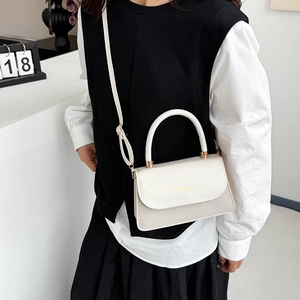 Elegant cream leather crossbody bag with woven panel detail and gold metal hardware