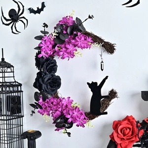 Halloween crescent moon wreath with black roses and cat silhouette on a white wall