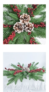 Close-up of artificial Christmas wreath with snowy pine cones and red berries on a branch