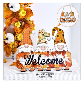 Close-up of wooden gnome Welcome sign with autumn maple leaves and pumpkin decor
