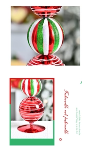 Detailed view of triple-tiered Christmas tree ornament with glitter balls and red stand