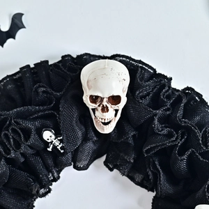Halloween wreath featuring black mesh burlap with white skull and bat decorations