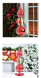 Detail of a stacked finial Christmas ornament in red, green and white with spiral patterns
