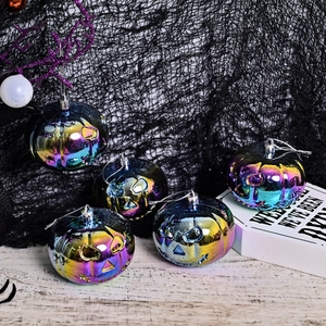 Set of 5 iridescent Halloween pumpkin ornaments with Jack-O-Lantern cutouts for decor