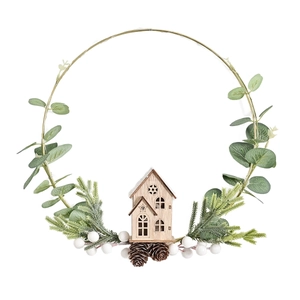 Christmas wreath with golden metal ring featuring pine cones and a wooden house