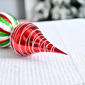 Red and green striped Christmas cone ornament with glitter detail and spiral texture