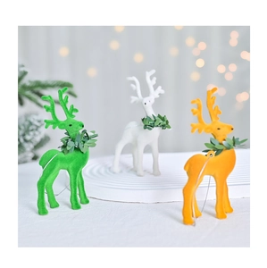 Detail of flocked reindeer ornaments in green, white, and orange for Christmas decor