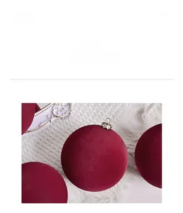 Detailed close-up of dark wine red velvet Christmas ball with elegant gold metal cap