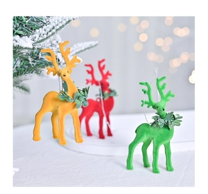 Close-up of colorful flocked reindeer ornaments with leaf neck details for Christmas tree