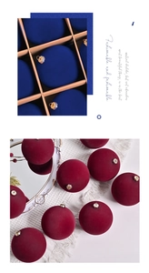 Detail of dark blue and burgundy flocked velvet Christmas balls with elegant hangers