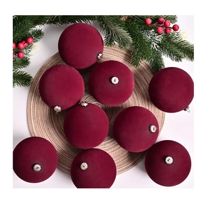 Detailed view of 9 deep burgundy velvet Christmas balls with ornate silver metal caps