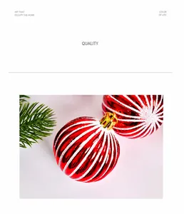 Close-up of red Christmas ball with white glitter spirals and a gold hanging cap