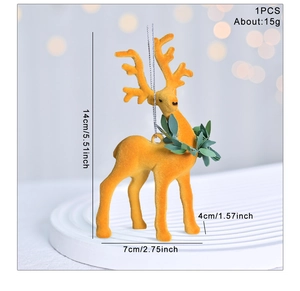 Detail view of flocked yellow reindeer ornament with dimensions 14x7x4cm and green leaf decor