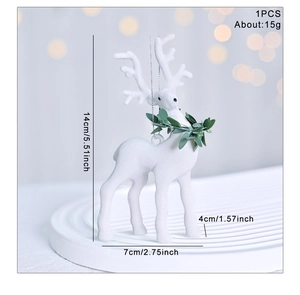 Close-up of a white flocked reindeer ornament with green collar and silver hanging cord