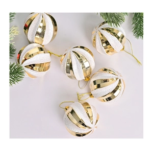 Detail of gold and white spiral Christmas ornaments with glitter and metallic finish