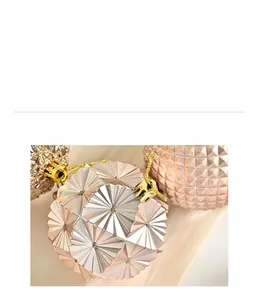 Detail of champagne and pink Christmas balls with faceted and embossed textures