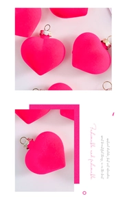 Macro view of neon pink flocked heart ornament with textured matte velvet and silver metal cap
