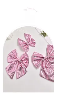 Detail view of pink sequin bow Christmas ornaments with metallic shimmering texture