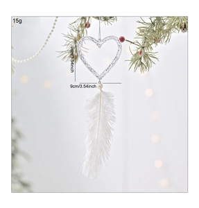 Macro shot of white feather heart ornament with silver glitter and pearl detail